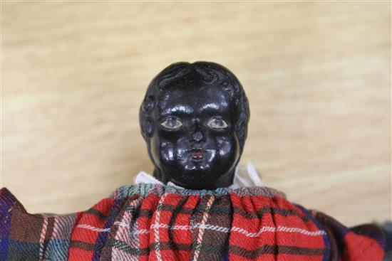 A Victorian doll wearing a tartan dress